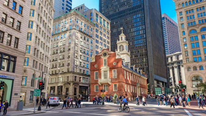 Boston, Massachusetts, USA - October 14, 2016: Pedestrians cross at the Old State House in Boston.