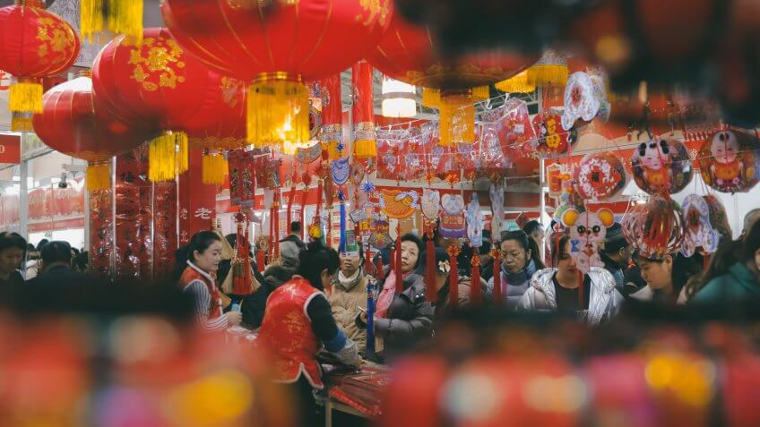 People shop for decorations for the upcoming Chinese Lunar New Year at a market in Beijing, China, 15 January 2020.