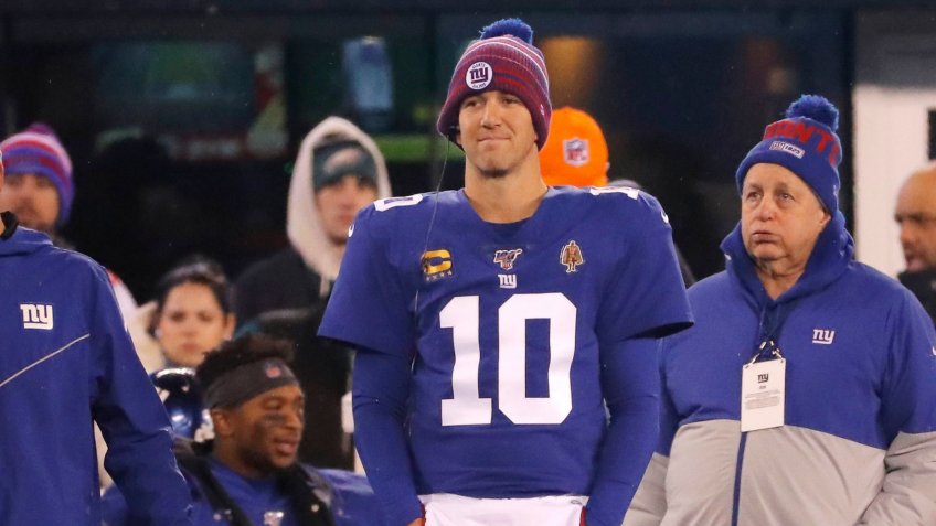 New York Giants quarterback Eli Manning (10) stands on the sidelines in the first half of an NFL football game against the Philadelphia Eagles, in East Rutherford, N.