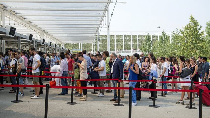 Fans stand in line before football game.