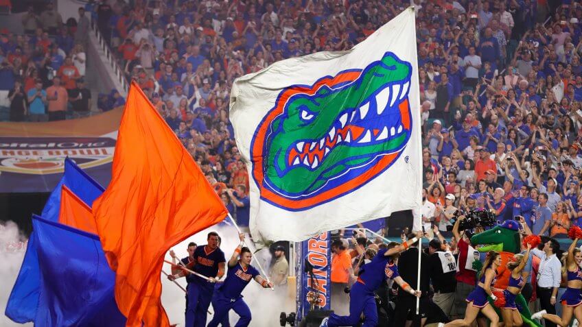 Mandatory Credit: Photo by Mario Houben/CSM/Shutterstock (10515365bh)The Florida Gators display their flags as the football team enters the field for the Capital One Orange Bowl - NCAA Football game against the Virginia Cavaliers at the Hard Rock Stadium in Miami Gardens, Florida.