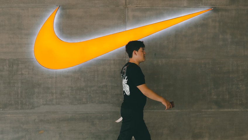 A Chinese man walks past a logo of Nike outside Nike store in Beijing, China, 22 May 2019.