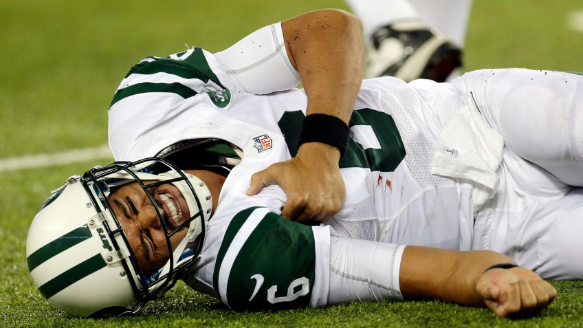 New York Jets quarterback Mark Sanchez (6) reacts to an injury during the second half of a preseason NFL football game against the New York Giants in East Rutherford N.