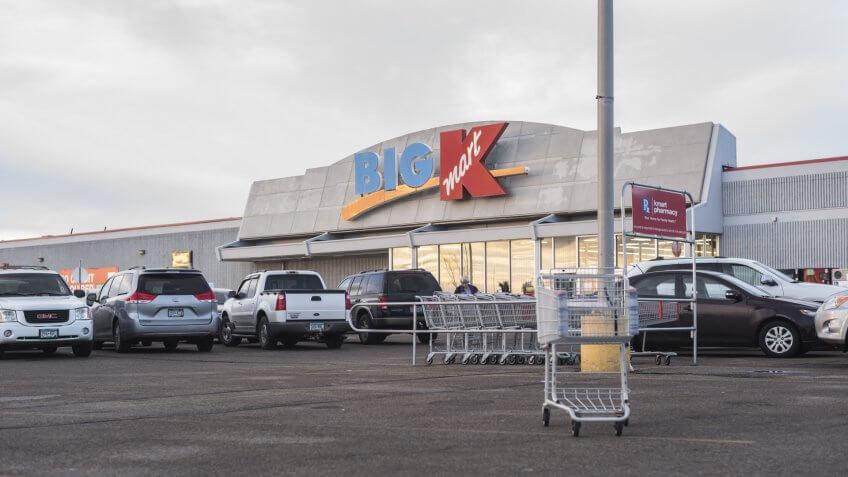 Moorhead, Minnesota, United States - December 7, 2015: Exterior of Big Kmart entrance with parking lot, with shopping carts in foreground.