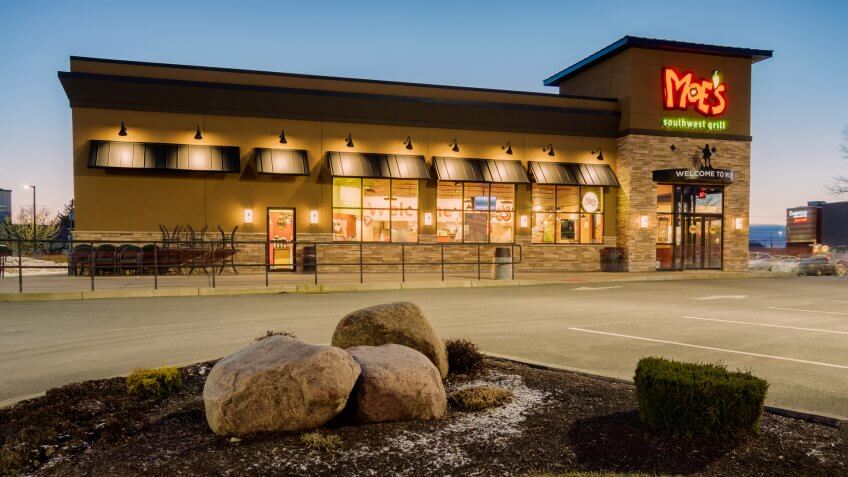 Utica, NY - DECEMBER 04, 2018: A Moe's Southwest Grill Restaurant Lit at Night.