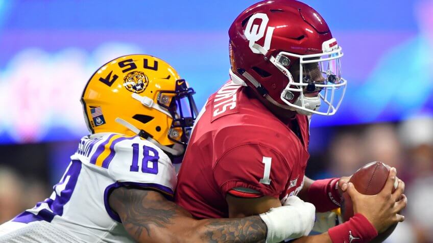 Mandatory Credit: Photo by John Amis/AP/Shutterstock (10514139aa)LSU linebacker K'Lavon Chaisson (18) sacks Oklahoma quarterback Jalen Hurts (1) during the first half of the Peach Bowl NCAA semifinal college football playoff game, in AtlantaCFP Peach Bowl Football, Atlanta, USA - 28 Dec 2019.