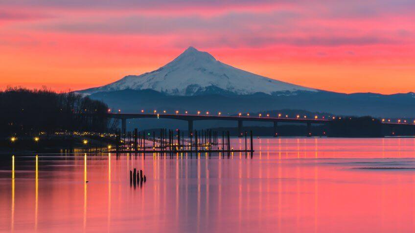 A vibrant pink sunrise over the Columbia River and Mt Hood, Portland Oregon.