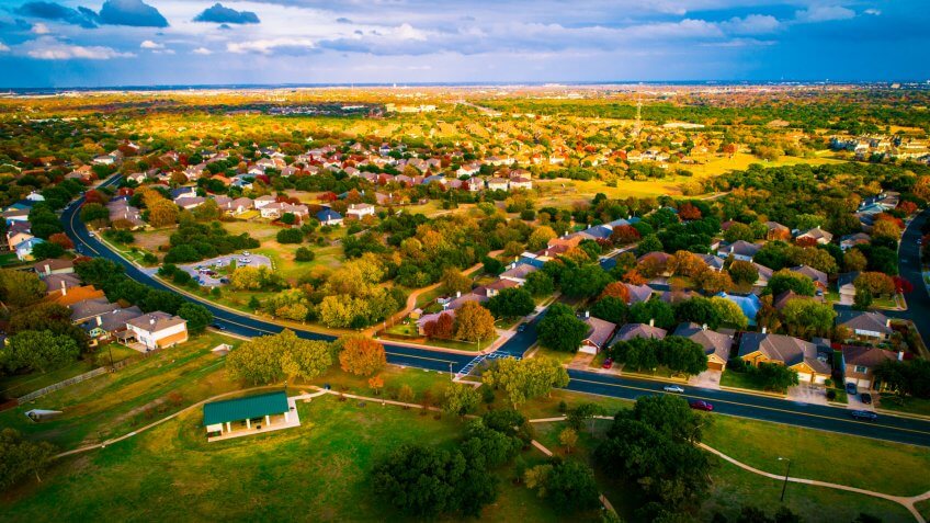 open Texas land for sale expanding housing development fall Autumn suburb suburbia round Rock Texas colorful landscape trees changing colors fall in central texas.