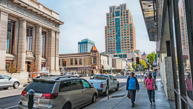 SACRAMENTO, CALIFORNIA, USA - SEPTEMBER 19, 2017: These two women are walking down J Street in downtown Sacramento past the historic bank and there are different views of different styles, this The downtown area is now known as DOCO for the many new shops in the Downtown Commons. On this sunny September day, the area was home to a hotel, sports arena, and unique old buildings.