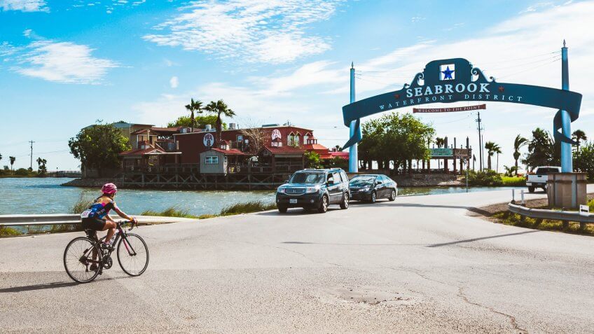 Seabrook, TX, US - Oct 21, 2018: Female cyclist enters the Seabrook Waterfront District on day 2 of the Bike Around The Bay Benefit ride in Seabrook Texas.