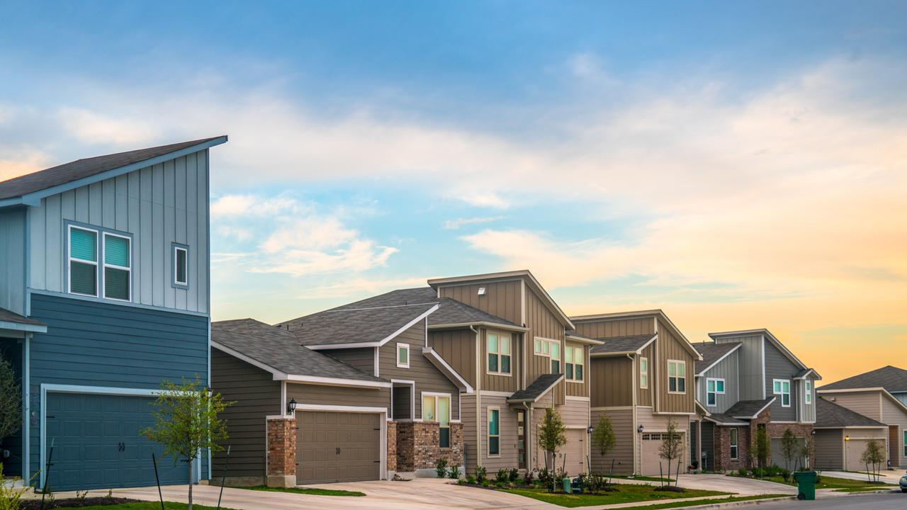 Real Estate Suburb New Development in Austin , Texas , USA - evening afternoon sunset bright sunshine on front yards and facade of new homes in Central Texas Neighborhood.