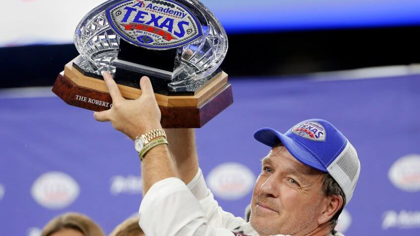 Mandatory Credit: Photo by Michael Wyke/AP/Shutterstock (10513792m)Texas A&M coach Jimbo Fisher holds up the Texas Bowl trophy after the team's 24-21 win over Oklahoma State in the NCAA college football game, in HoustonTexas Bowl Football, Houston, USA - 27 Dec 2019.