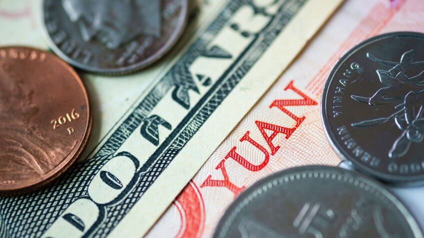 Close up banknote and coins of US dollar and Yuan which its are the biggest economic in the world.