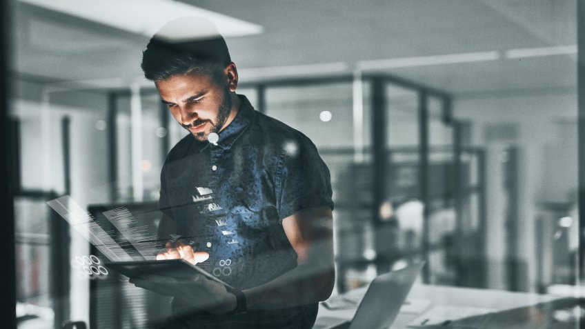 Cropped shot of a handsome young businessman working late in the office.