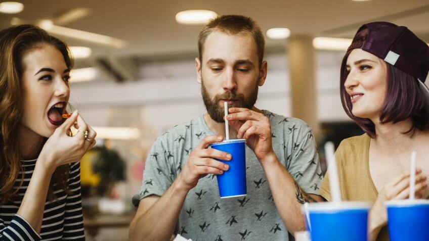 friends drinking from soda cups