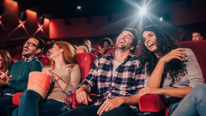 Happy four friends at cinema together.