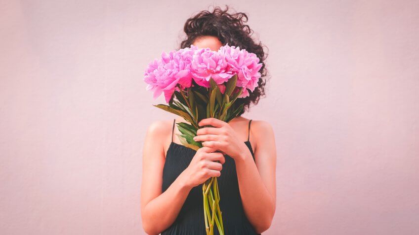woman holding bouquet of flowers