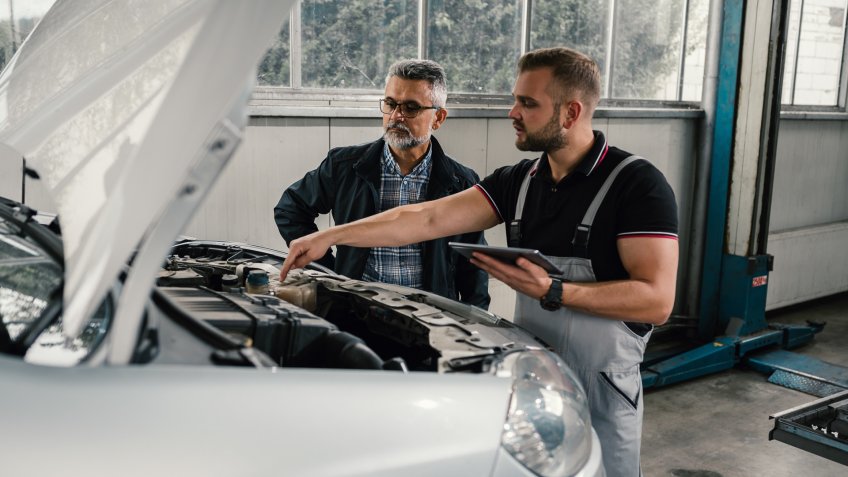 Auto mechanic with customer.