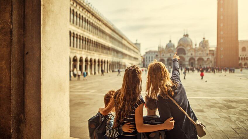 Mother and three kids visiting Venice, Italy.