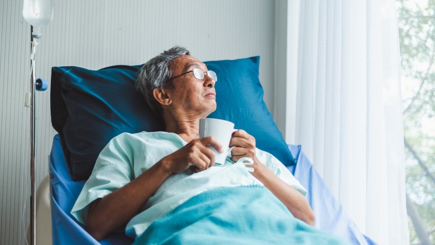 Lonely old asian patient on patient bed in hospital.