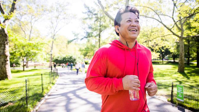 A mature hispanic man working out in central park in New York City.