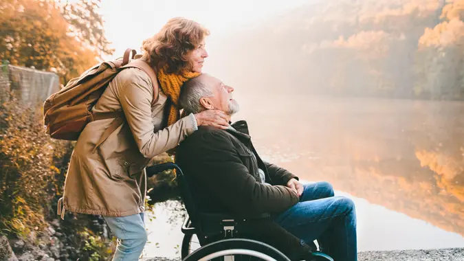 Active senior couple on a walk in a beautiful autumn nature.