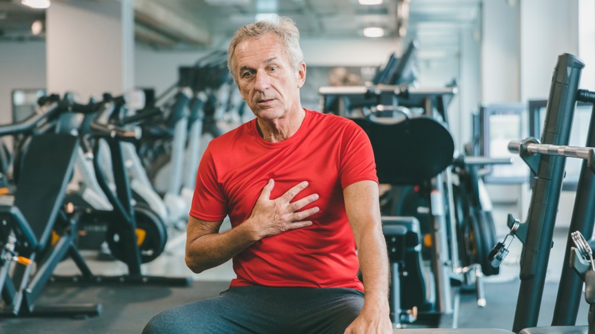 Shot of a elderly man feeling chest pain at gym.