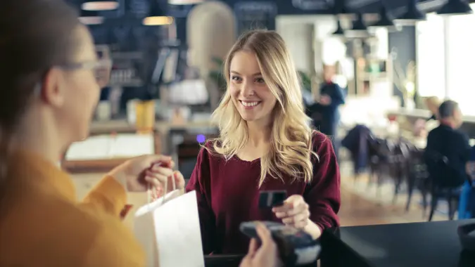 Young woman is buying something.
