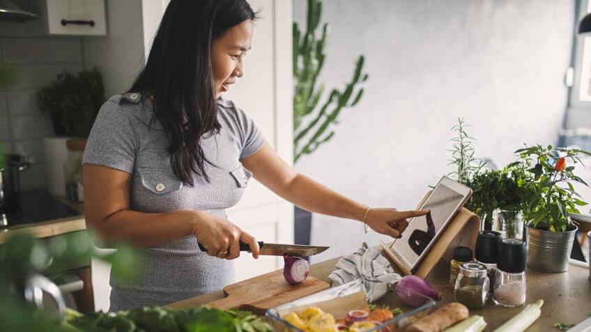 Asian women at home making healthy meal.