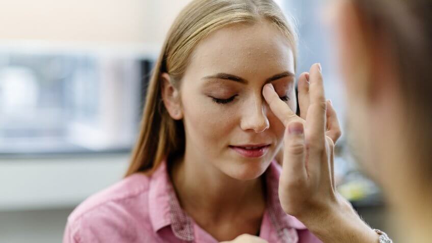 Female model getting her makeup done.