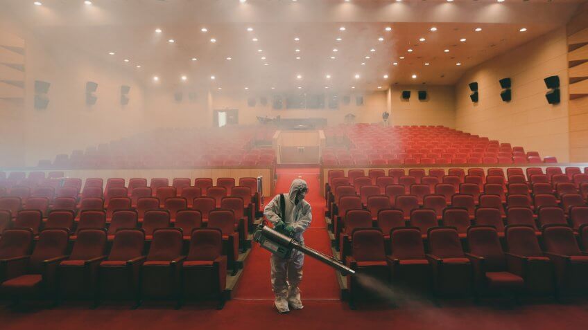 A worker wearing protective gears sprays antiseptic solution as a precaution against the spread of MERS, Middle East Respiratory Syndrome, virus at an art hall in Seoul, South Korea, .