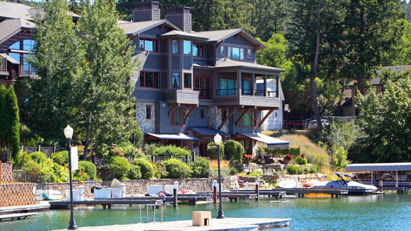 Bigfork,Montana,USA- August 18,2019: Waterfront Group of condos with small docks,boats, lamp posts and bags.
