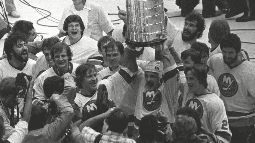 CUP New York Islanders Bryan Trottier, center, holds aloft the Stanley Cup as his teammates celebrate their second consecutive championshipSTANLEY CUP FINAL, UNIONDALE, USA.