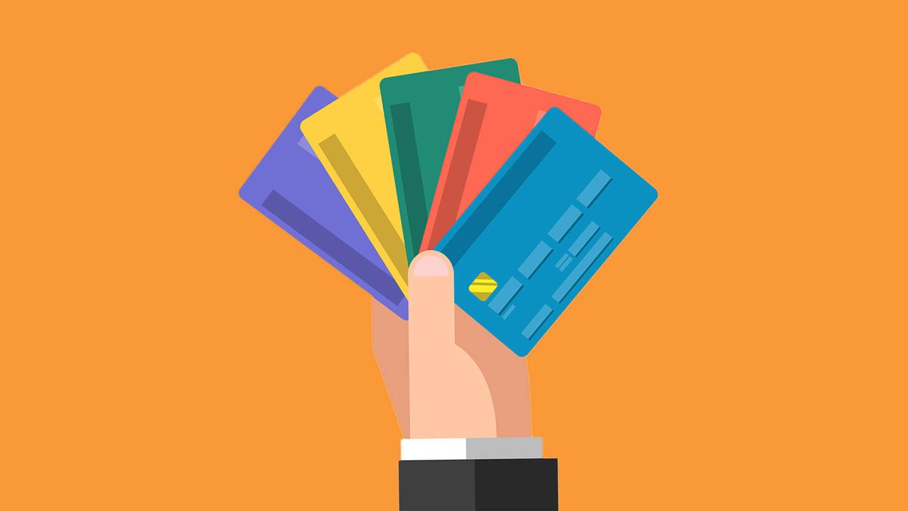 Various colored bank cards in one hand.