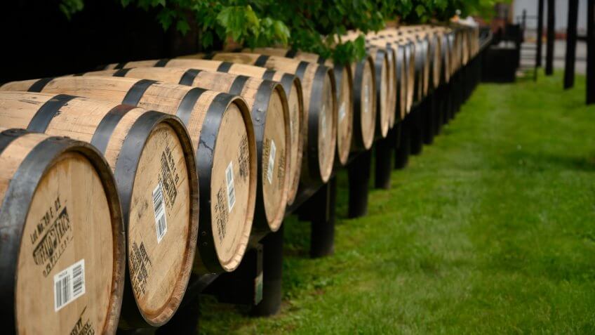 Versailles, United States: May 2, 2019: Line of Barrels Rolling into Warehouse along Kentucky bourbon trail.