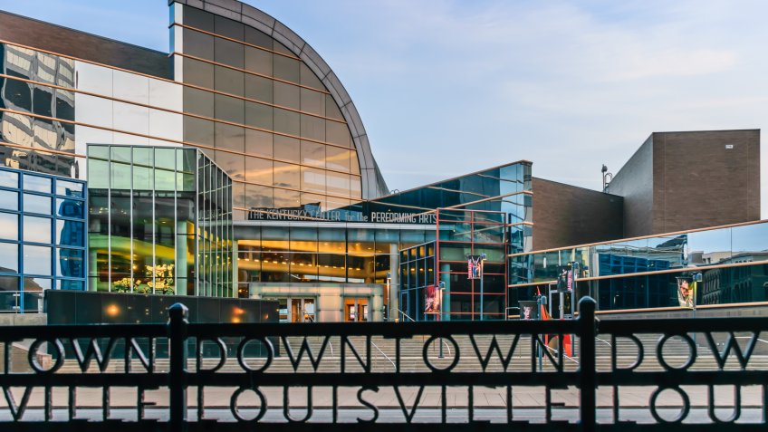 Louisville, Kentucky, USA - March 27th 2016: Kentucky Center for the Performing Arts building in Louisville Kentucky with rod iron fence which states "Downtown Louisville" in foreground.