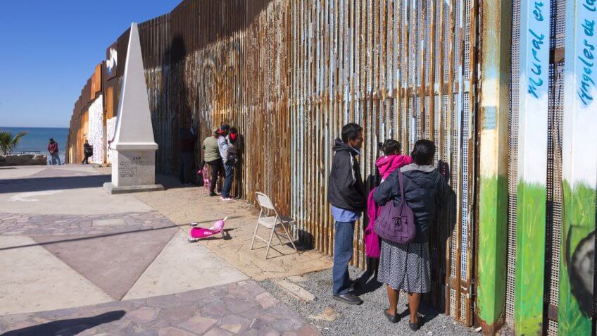 PLAYAS DE TIJUANA, MEXICO - JANUARY 28, 2017: Mexican families living in Tijuana visit with family living in the U.
