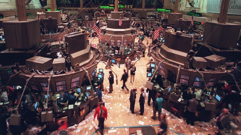 WALL STREET New York stock exchange traders walk the floor after the close of the exchange, where the Dow Jones industrial average surged 55.