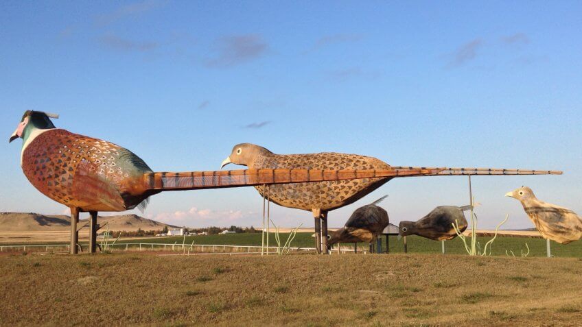Regent, ND/USA-Oct 2, 2015: A 30-mile stretch of road in west North Dakota is dubbed “the Enchanted Highway” for its eight oversized folk art sculptures, such as this metal "Pheasants on the Prairie.