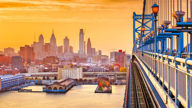 Philadelphia, Pennsylvania, USA downtown skyline from the Benjamin Franklin Bridge at twilight.