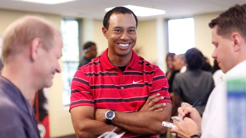 Tiger Woods Tigers Woods smiles as he answers questions for local journalist after speaking at Cesar Chavez Charter High School in Washington, .