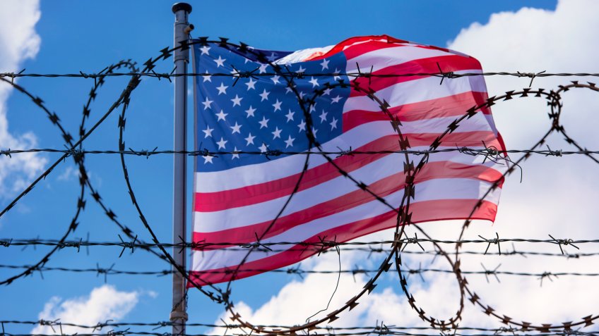 USA Border with American Flag and barbed Wire.