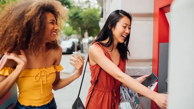 Women taking money from the ATM.