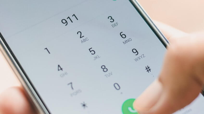 Emergency and urgency, dialing 911 on smartphone screen.