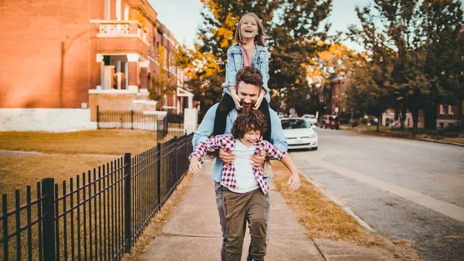 Close up of a young father having a walk with his kids.