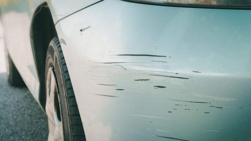 Scratched car with deep damage to the paint.
