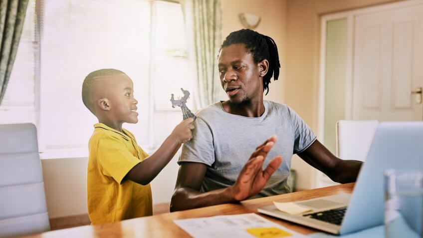 Cropped shot of an adorable little boy trying to be playful with his father at home.
