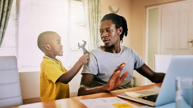 Cropped shot of an adorable little boy trying to be playful with his father at home.