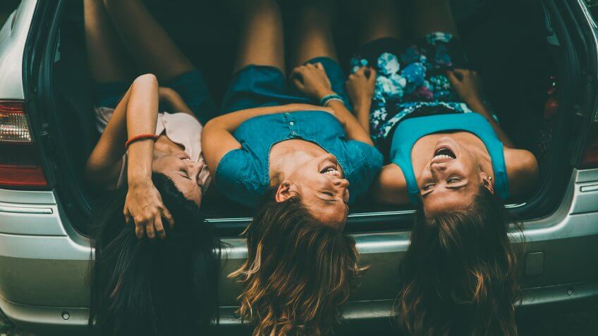 A group of friends having fun in the car.