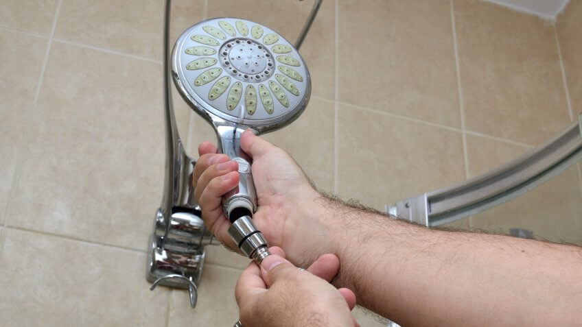 Installing a new shower hose on an used showerhead.